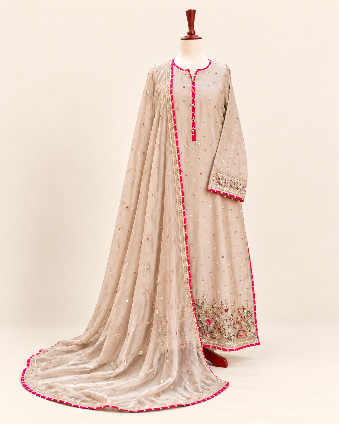 Ivory three-piece suit with pink borders, embroidered motifs and matching sheer dupatta
